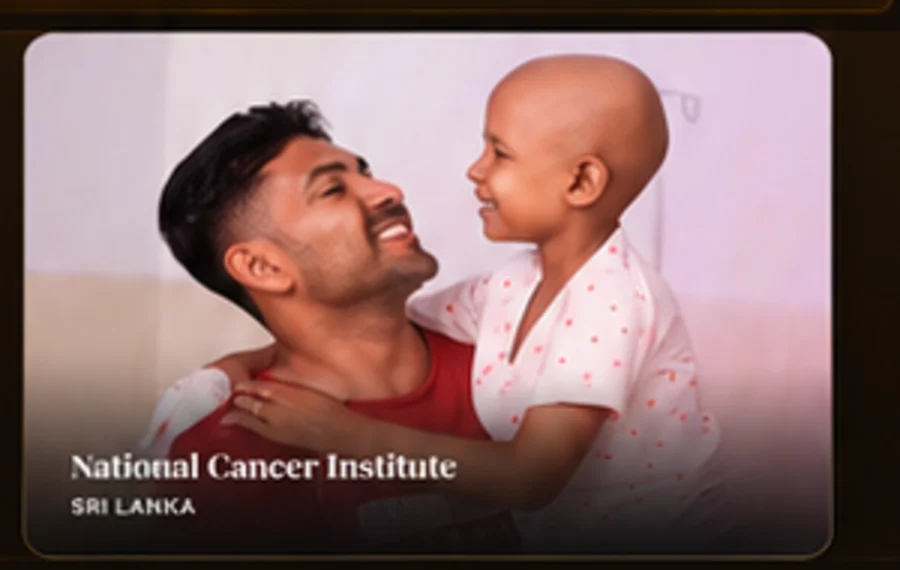 A father smiling with a child receiving cancer treatment